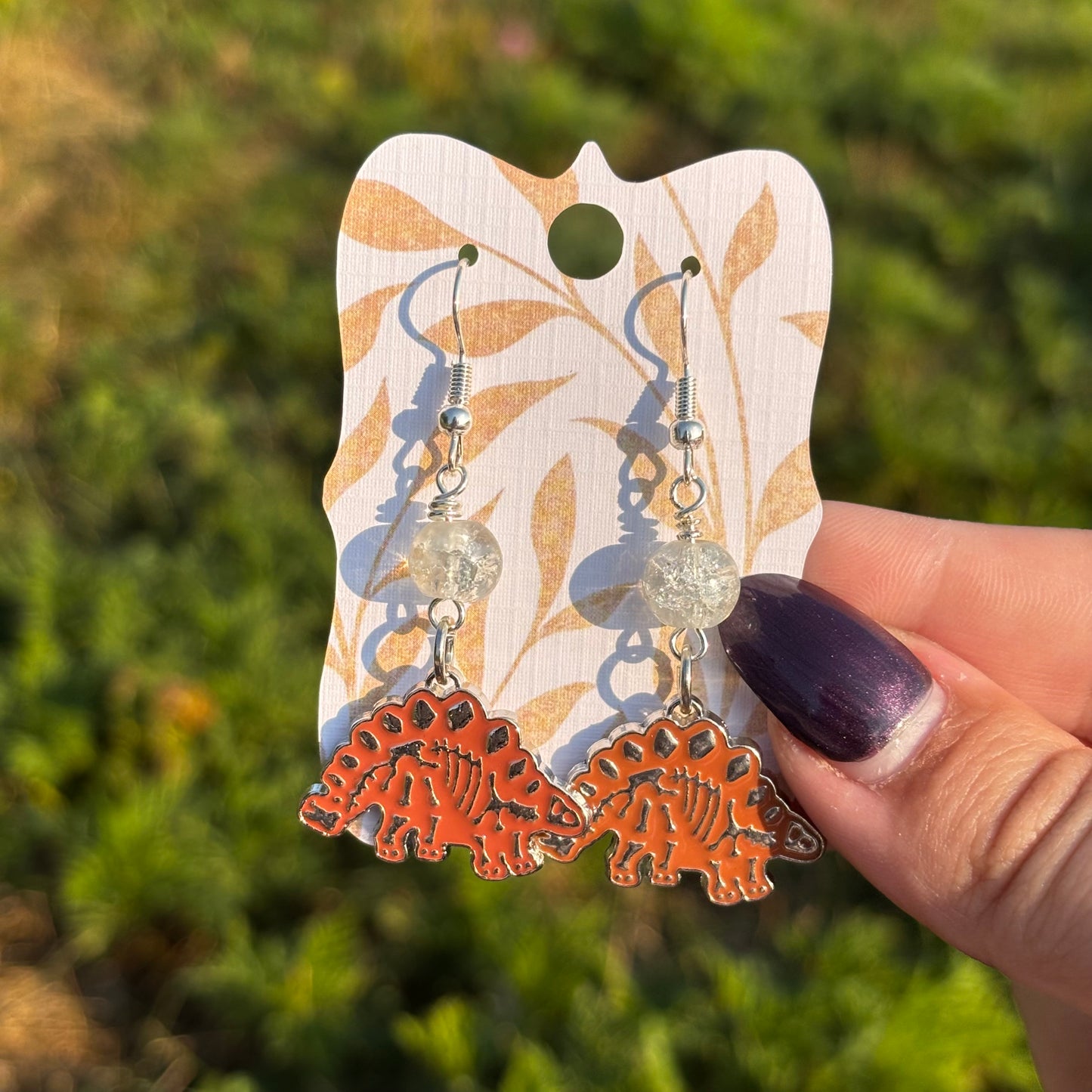 Katie - Stegosaurus Orange Skeleton Earrings!