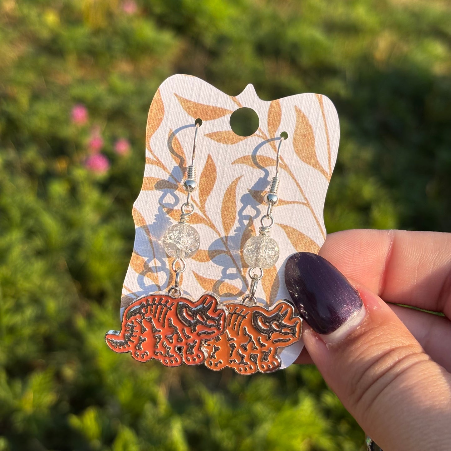 Katie - Triceratops Orange Skeleton Earrings!